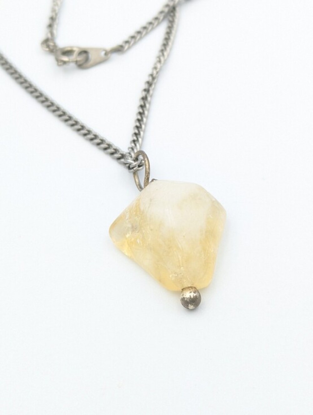 Silver tone chain necklace with yellow stone pendant